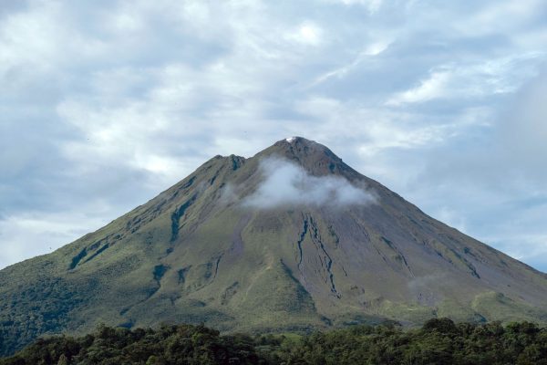shot-breathtaking-giant-mountain-covered-forests-gleaming-cloudy-sky
